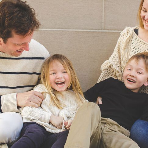 laughing family with two young kids - family photography