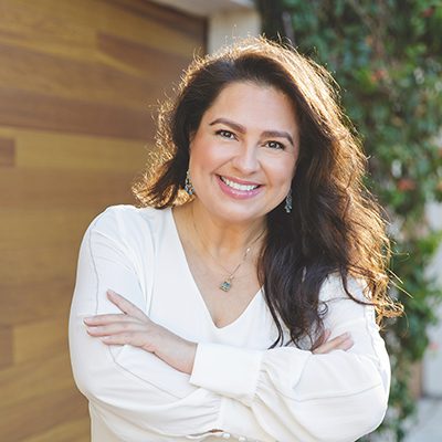 light skinned woman with dark brown hair in a white shirt is smiling at the camera - plano personal branding photography