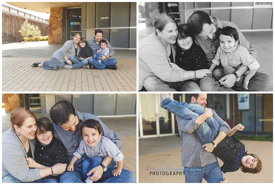 outdoor family photos in addison circle with bricks, large blue sculpture, and a light skinned family with dark hair, mom, dad, and two boys, all in shades of gray, black and denim